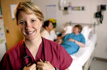 nurse smiling with patient in background
