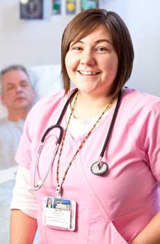 nurse smiling with patient in background