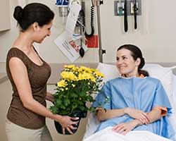 patient with visitor and flowers